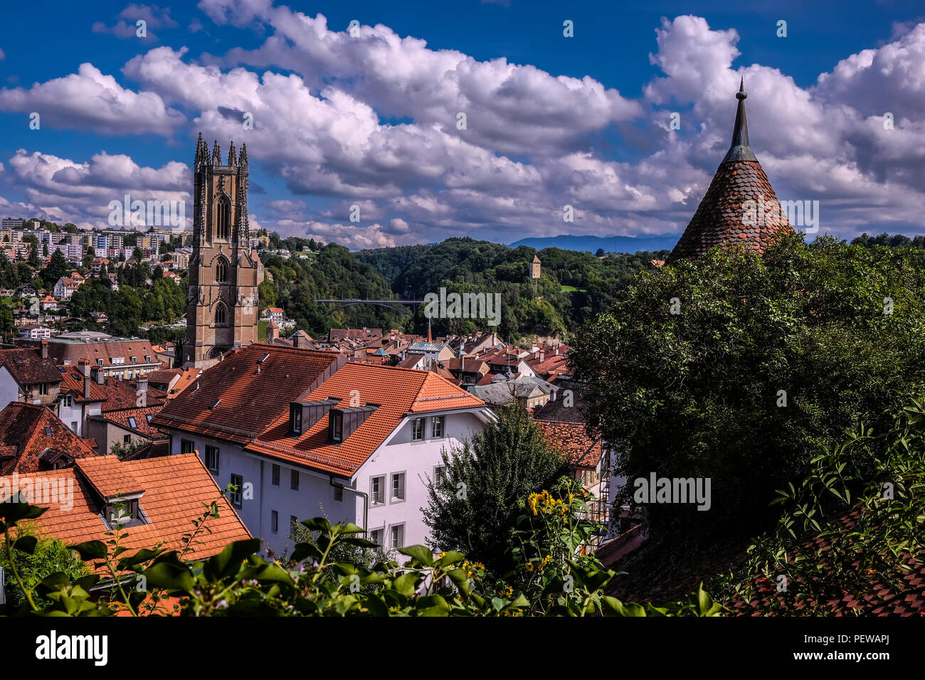 Landscape view of the city of Fribourg, in Switzerland with the Saint-Nicolas cathedral in the center and the Schönberg area in the background Stock Photo