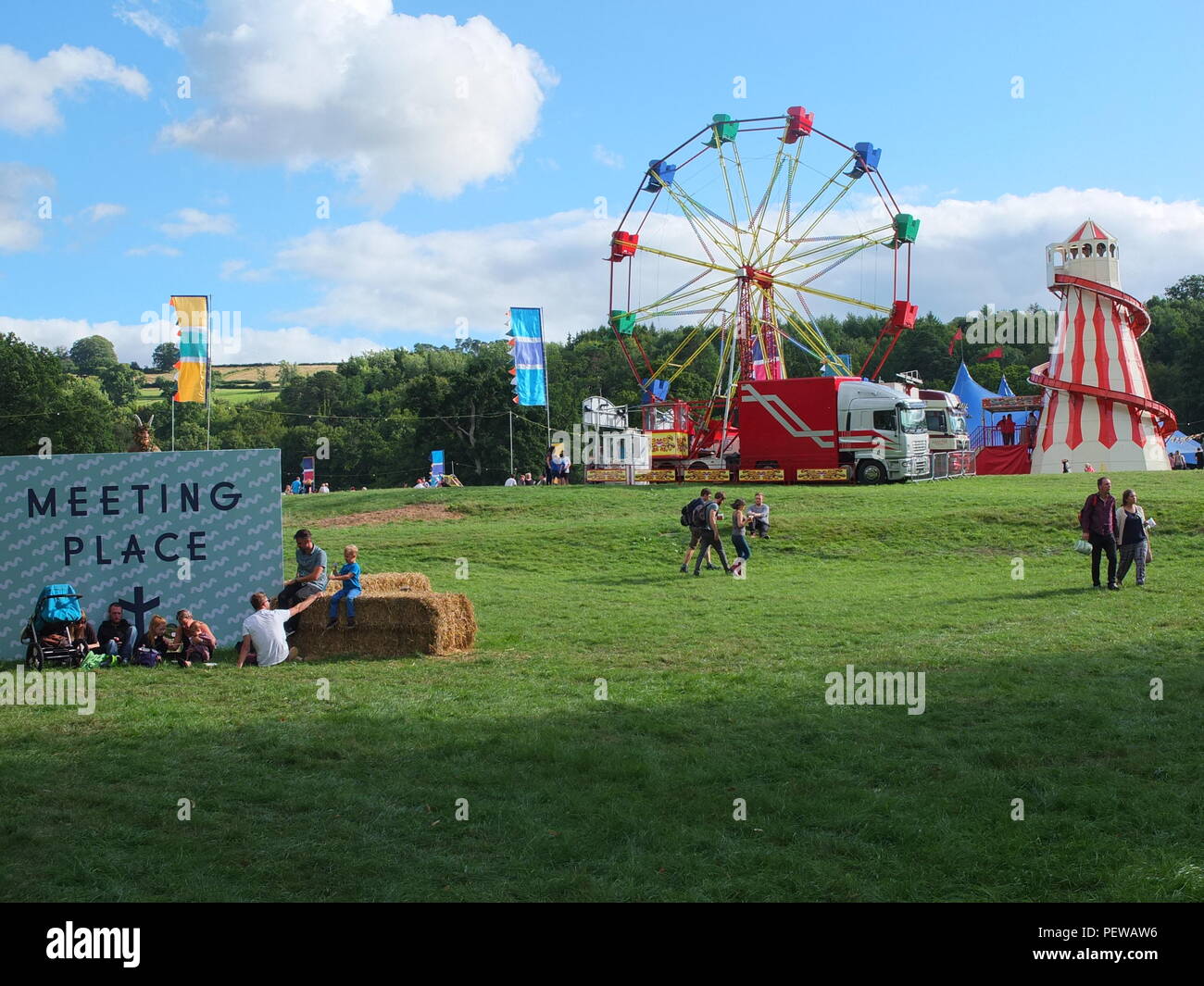 Green Man Festival, Wales. Families sit on hay bales at the festival ...