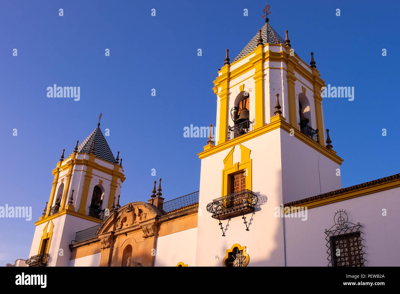 Landscape view of the Church of Socorro in Ronda, with the two bell towers in the foreground and deep blue sky in the background Stock Photo