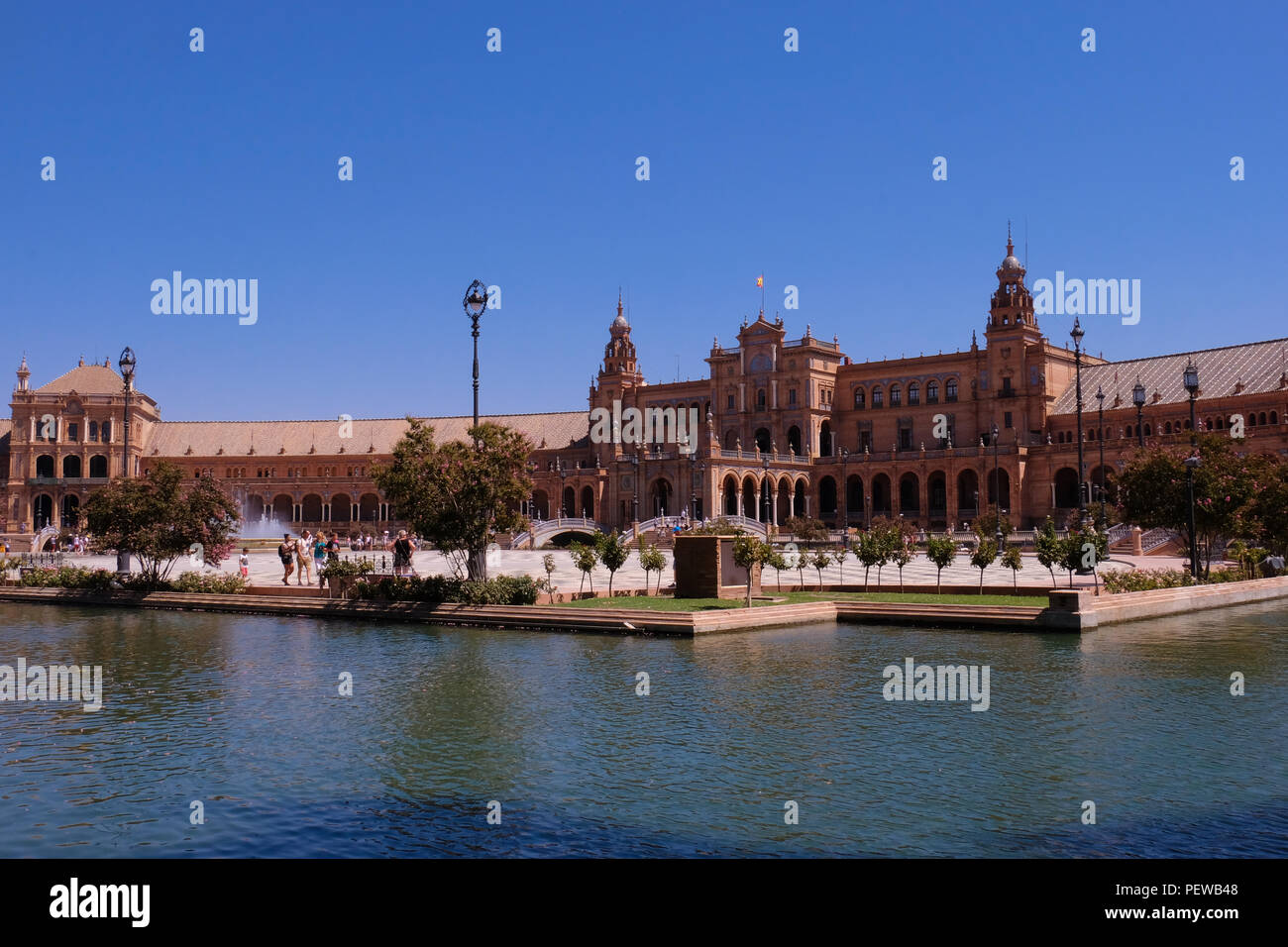Landscape view of the plaza de Espana on the Parque de María Luisa in Sevilla, Spain, with water from the fountains in the foreground Stock Photo