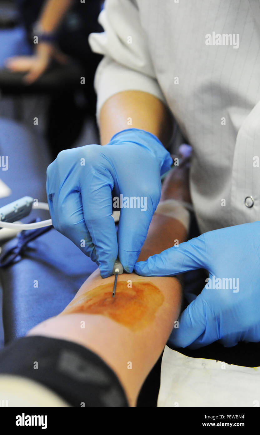 Donation Inset A collection specialist from the American Red Cross prepares to insert ...