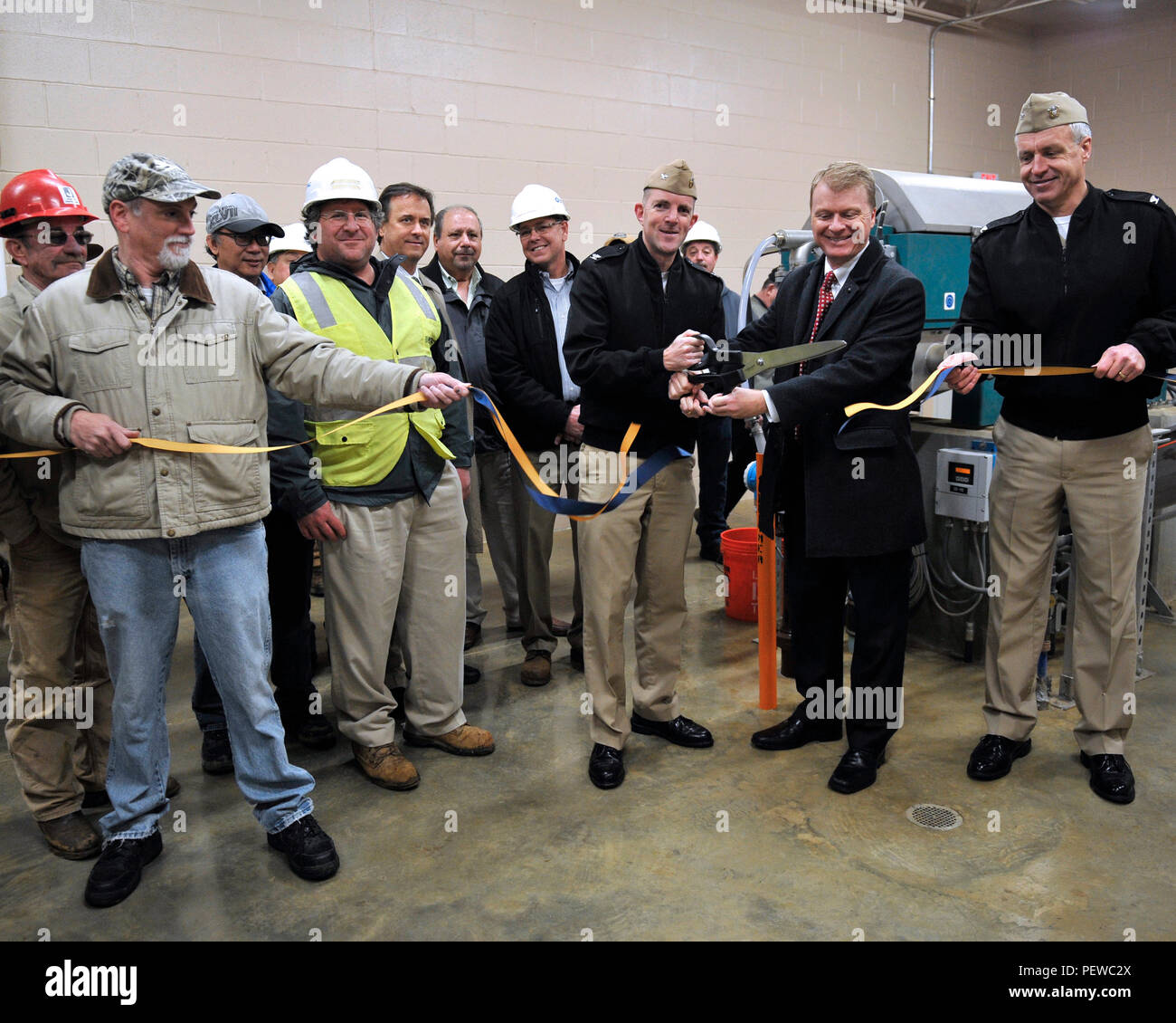 160203-N-ZA795-012   WASHINGTON (Feb. 3, 2016)  Naval Academy Public Works Officer Capt. Nicolas Merry and Naval Support Activity (NSA) Annapolis Commanding Officer Logan Jones along with members of Baltimore Water and Electric Company and Naval Facilities and Engineering Command employees participate in a ribbon cutting and open house. This is the first event showcasing energy conservation measures Naval District Washington (NDW) and Naval Facilities Engineering Command Washington have on tap for the Secretary of the Navy Great Green Fleet initiative. (U.S. Navy photo by Mass Communication Sp Stock Photo