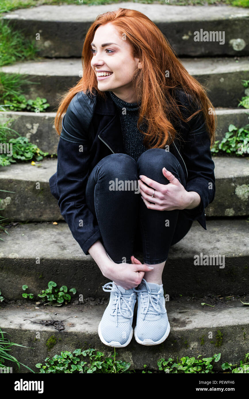 Woman sitting on rock steps hi-res stock photography and images - Alamy