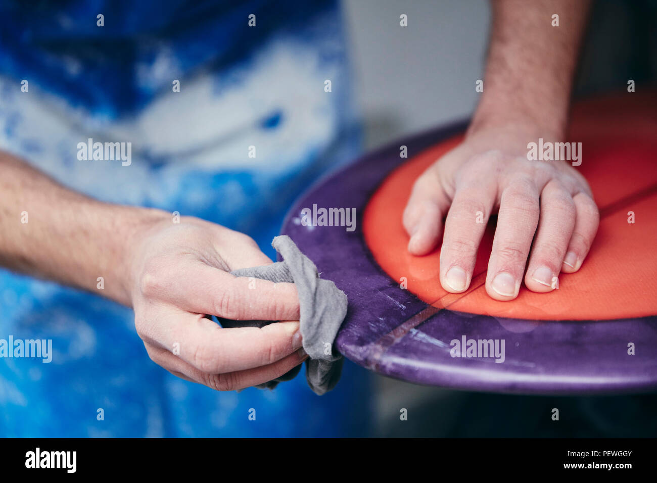 Man sanding and shaping a surfboard in a Stock Photo Alamy