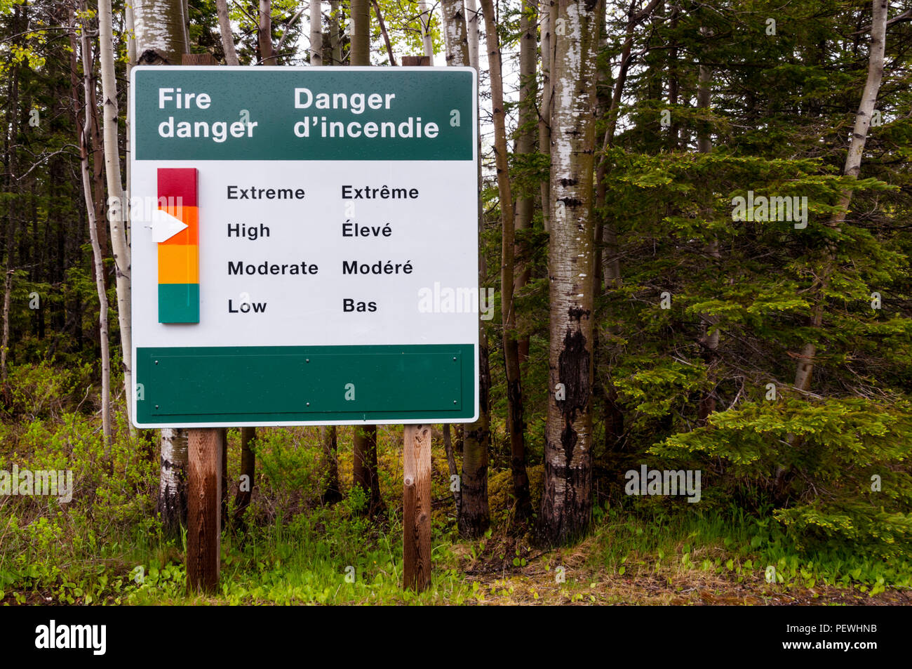 English & French bi-lingual fire danger indicator in Terra Nova National Park, Newfoundland, Canada. Stock Photo