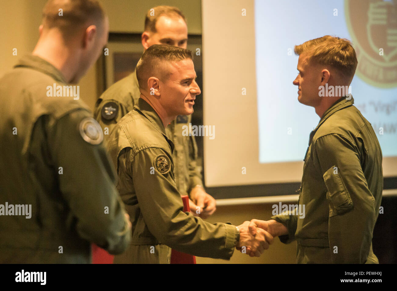 Col. James H. Adams, center, congratulates Capt. John J. Kress during ...