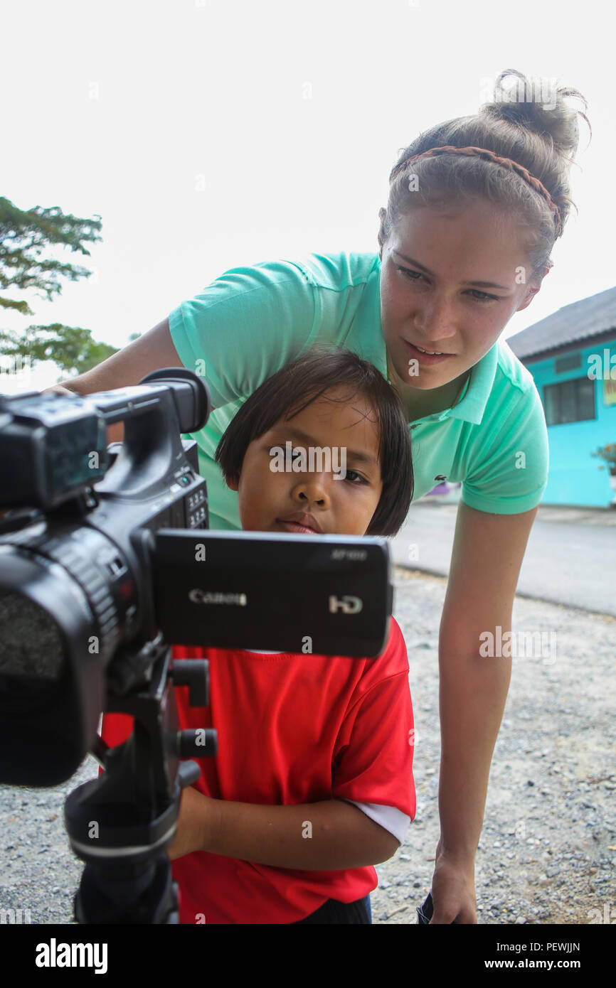 U.S. Marine Corps Lance Cpl. Brooke Dieters, a Combat Videographer with Marine Corps Installations Pacific, a Carlyle, Ill. native, shows a student a video camera at the Kao Chi Chan School, during exercise Cobra Gold in Sattahip, Thailand, Feb. 14, 2016. Cobra Gold is a multinational training exercise developed to strengthen security and interoperability between the Kingdom of Thailand, the U.S. and other participating nations. (U.S. Marine Corps Combat Camera photo by Lance Cpl. Jeremy L. Laboy/Released) Stock Photo