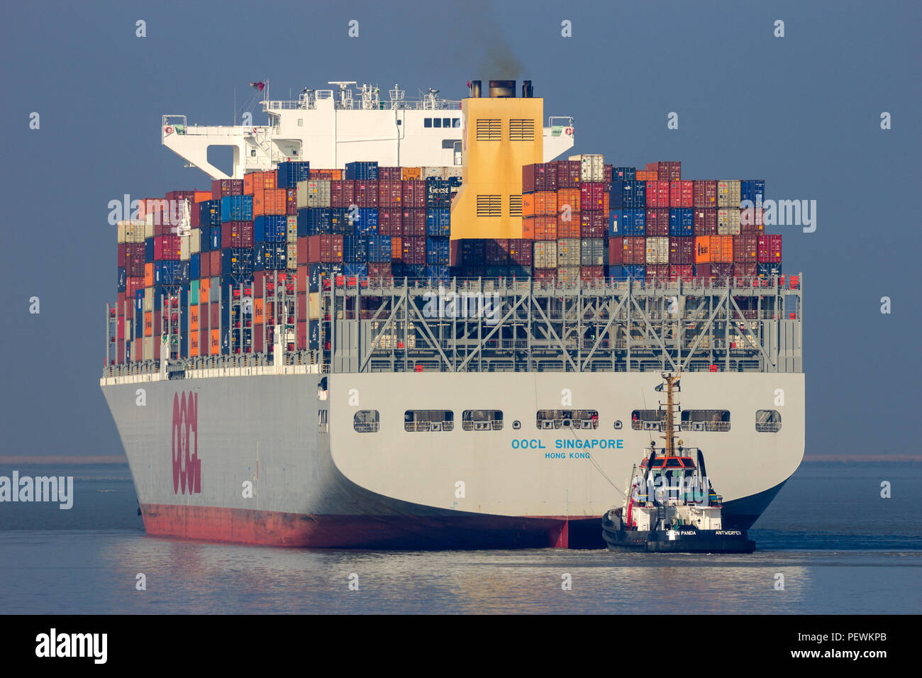 ANTWERP, BELGIUM - MAR 12, 2016: Container ship OOCL Singapore leaving a container terminal in the Port of Antwerp. Stock Photo