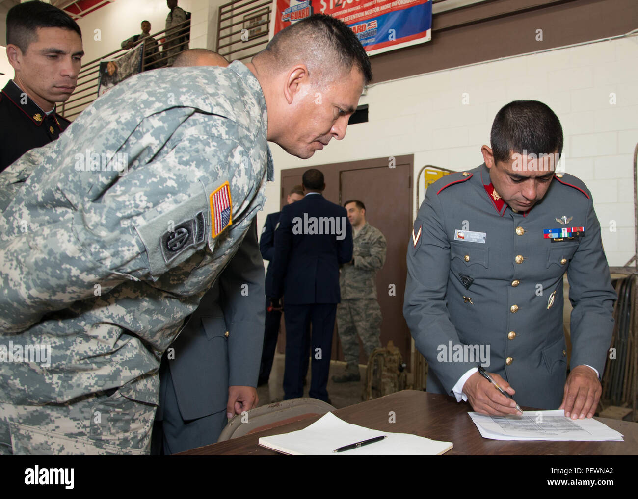 Chilean Army Sgt. 1st Class Luis Herrera, a Chilean military competitor, registers for the essay portion of the Best Warrior Competition with help from his sponsor, U.S. Army Sgt. 1st Class Juan Barragan, Feb. 4, 2016, at Camp Swift, Texas. This is the first year that the Chilean military is participating in the BWC as part of the state partnership program with the Texas Military Department. (Texas Air National Guard photo by Tech. Sgt. Vanessa Reed/Released) Stock Photo