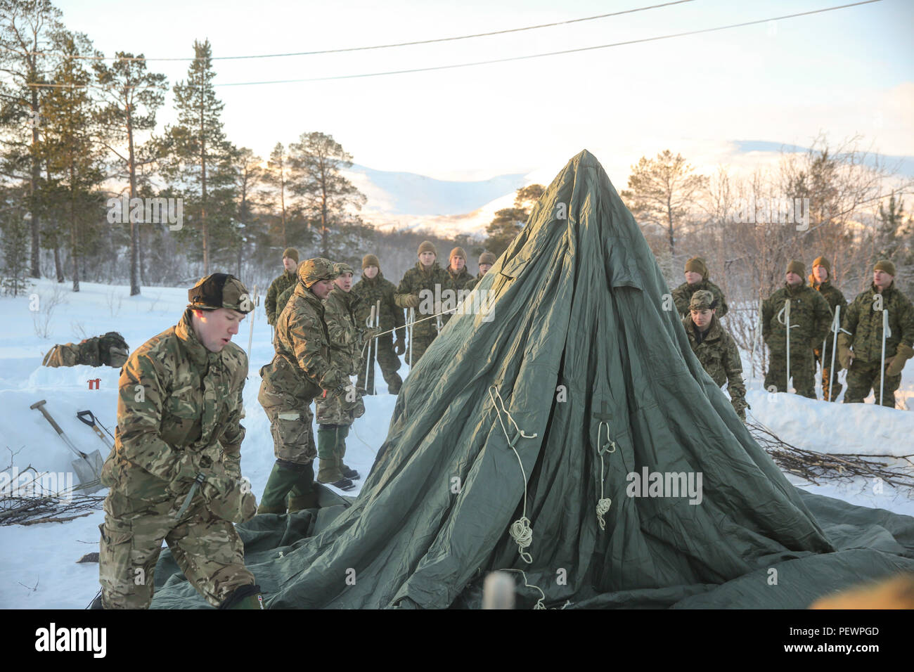 Mountain leaders from the U.K. Royal Commandos demonstrate how to properly  set up 10-man tents to Marines with Black Sea Rotational Force aboard  Porsangmoen, Norway, Feb. 2, 2016. The Arctic training was