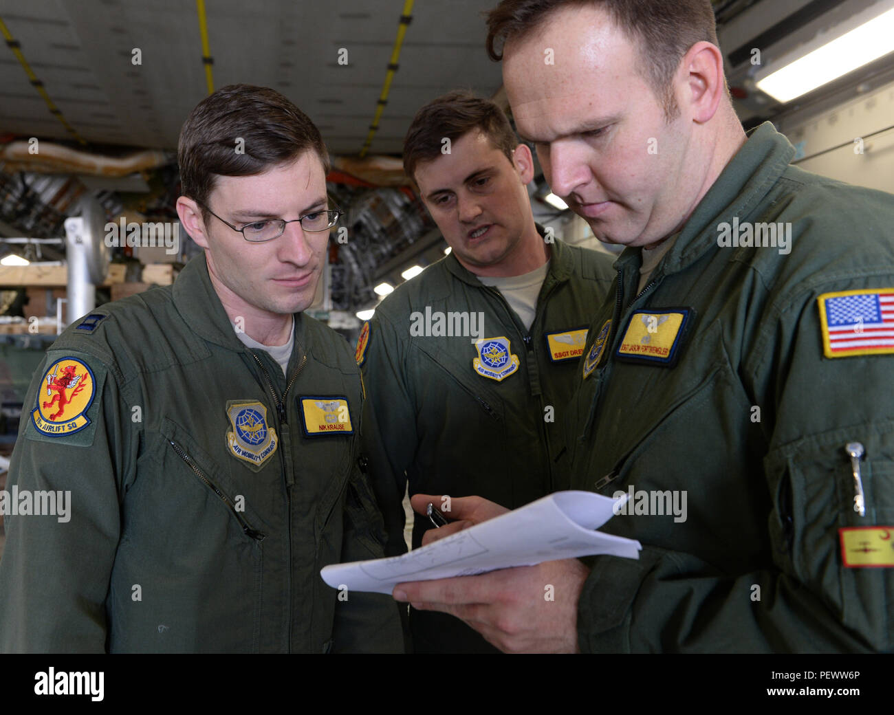 U.s. Air Force Capt. Nikolaus Krause, Staff Sgt. Drew Carey, And Staff Sgt.  Jason Fortwengler, 16Th Airlift Squadron, Joint Base Charleston, S.c.,  Checks The Weight Of The Load On A C-17 Globemaster