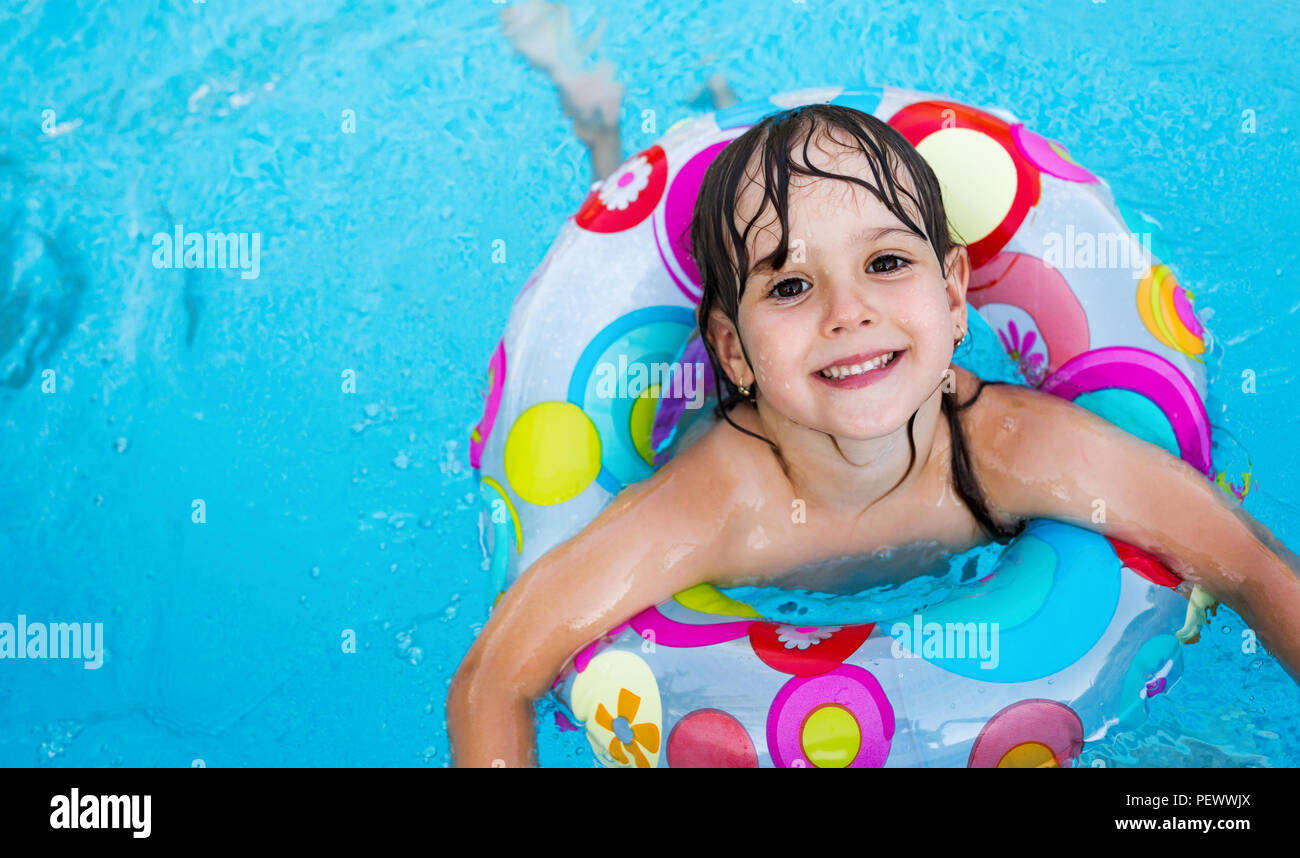 Little girl in swimming pool with float ring Stock Photo Alamy