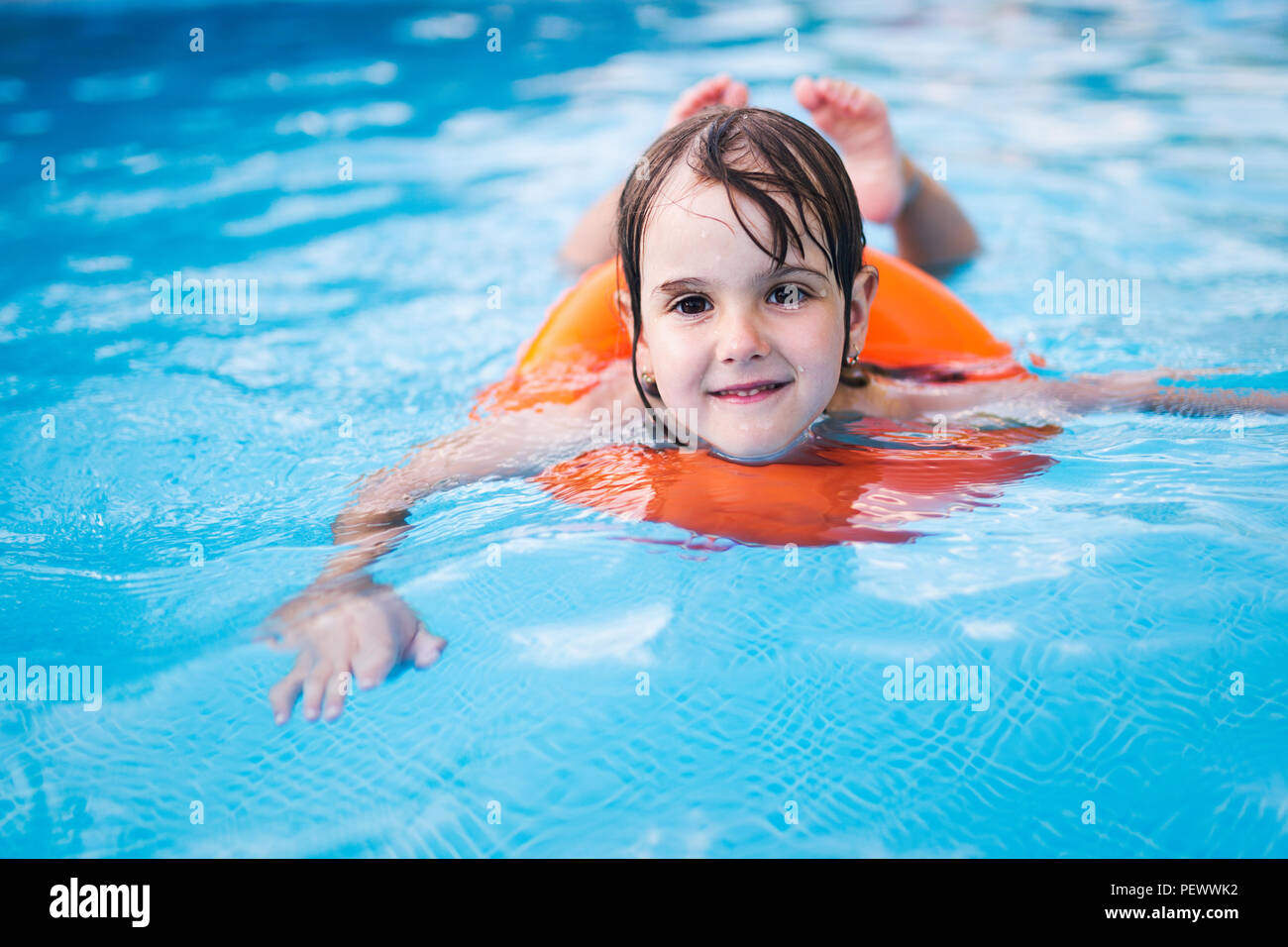 Little girl in swimming pool with float ring Stock Photo Alamy