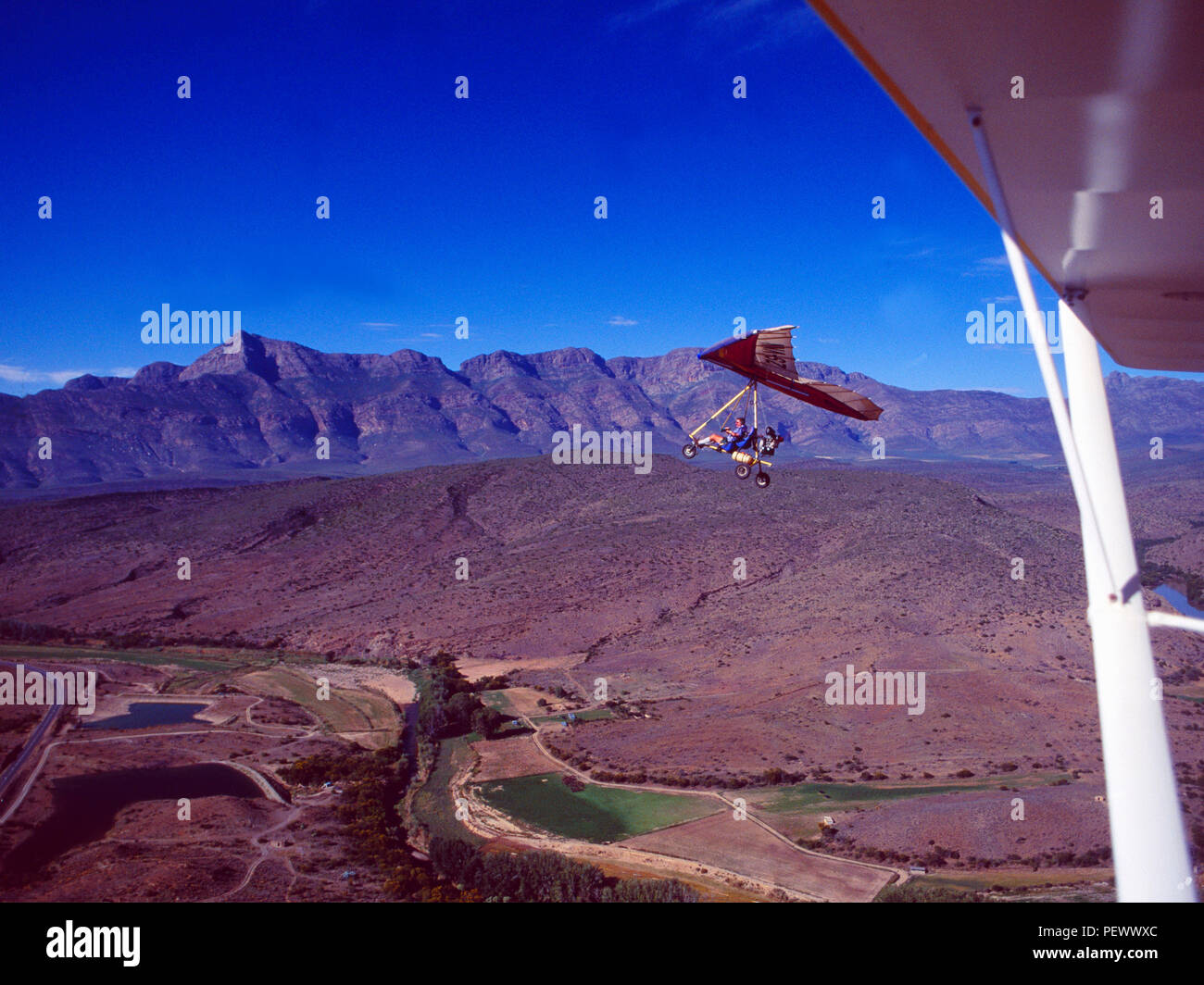 South Africa: Hangglider over the Swartberg-Mountains in the little Karoo near Klaarstroom Stock Photo