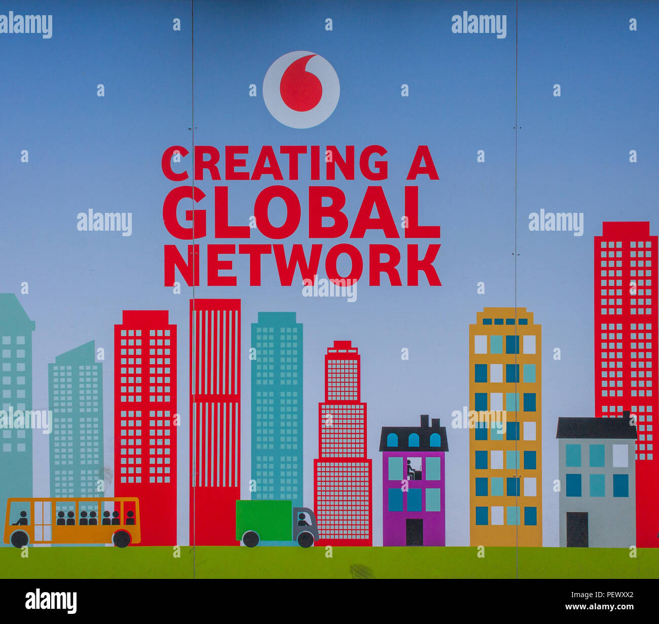Vodafone logo advertising a global network on an advertising hoarding, or advertising board. Stock Photo