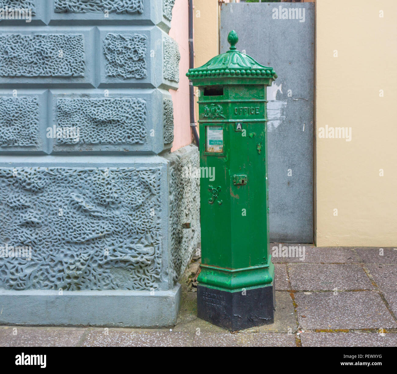 Cast Iron Irish post box painted green. Stock Photo