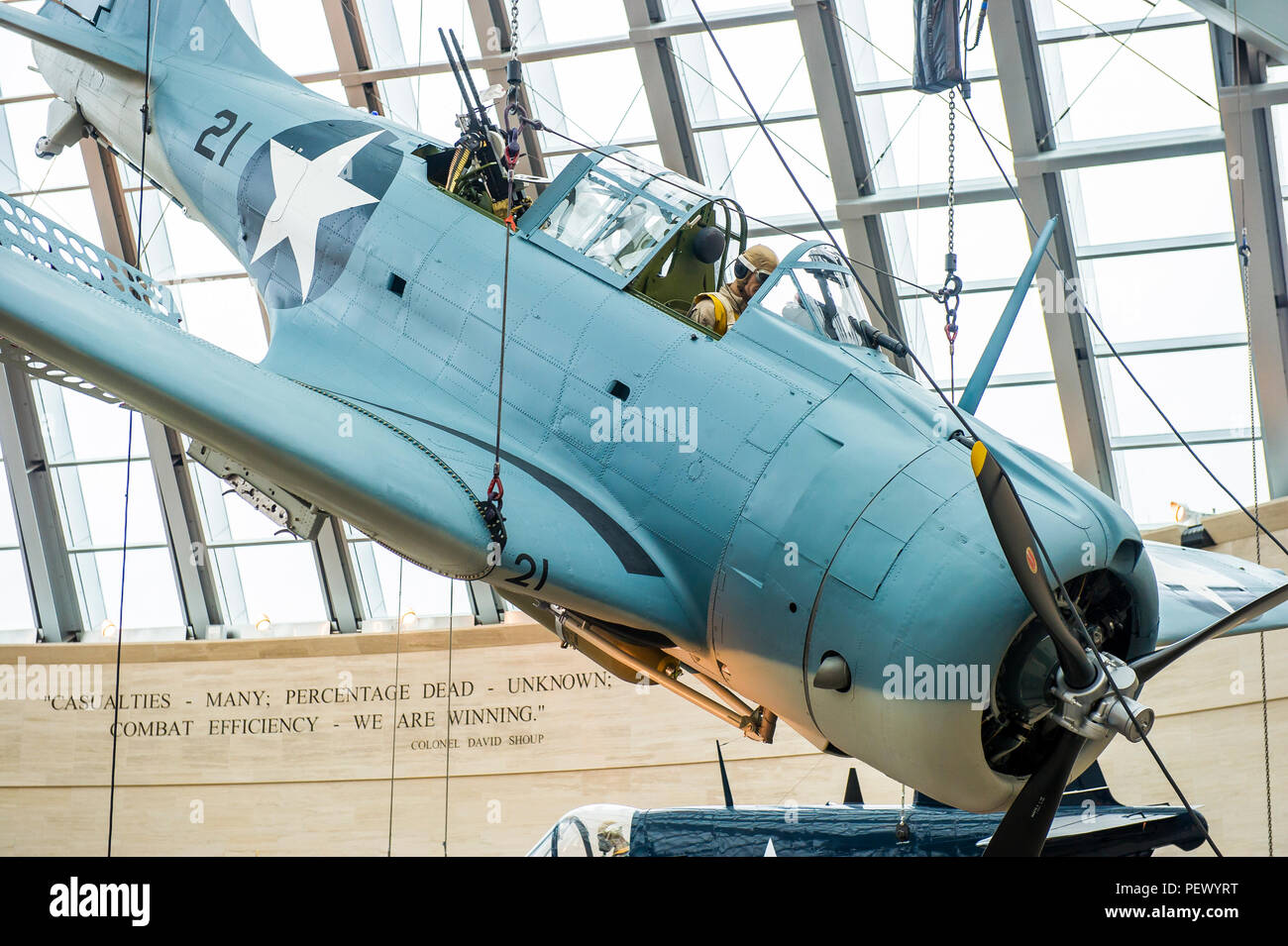 An SBD-3 (Scout Bomber Douglas) Dauntless, is weight tested, lifted and installed as part of the World War II exhibit at the National Museum of the Marine Corps, Triangle, Va., Feb. 9, 2016. This fully restored, donated aircraft has been painted to represent the SBD-3 flown by Maj. Richard C. Mangram and Cpl. Dennis E. Byrd during the Guadalcanal Campaign on Aug. 25, 1942. (Official United States Marine Corps photo by Kathy Reesey/Released) Stock Photo