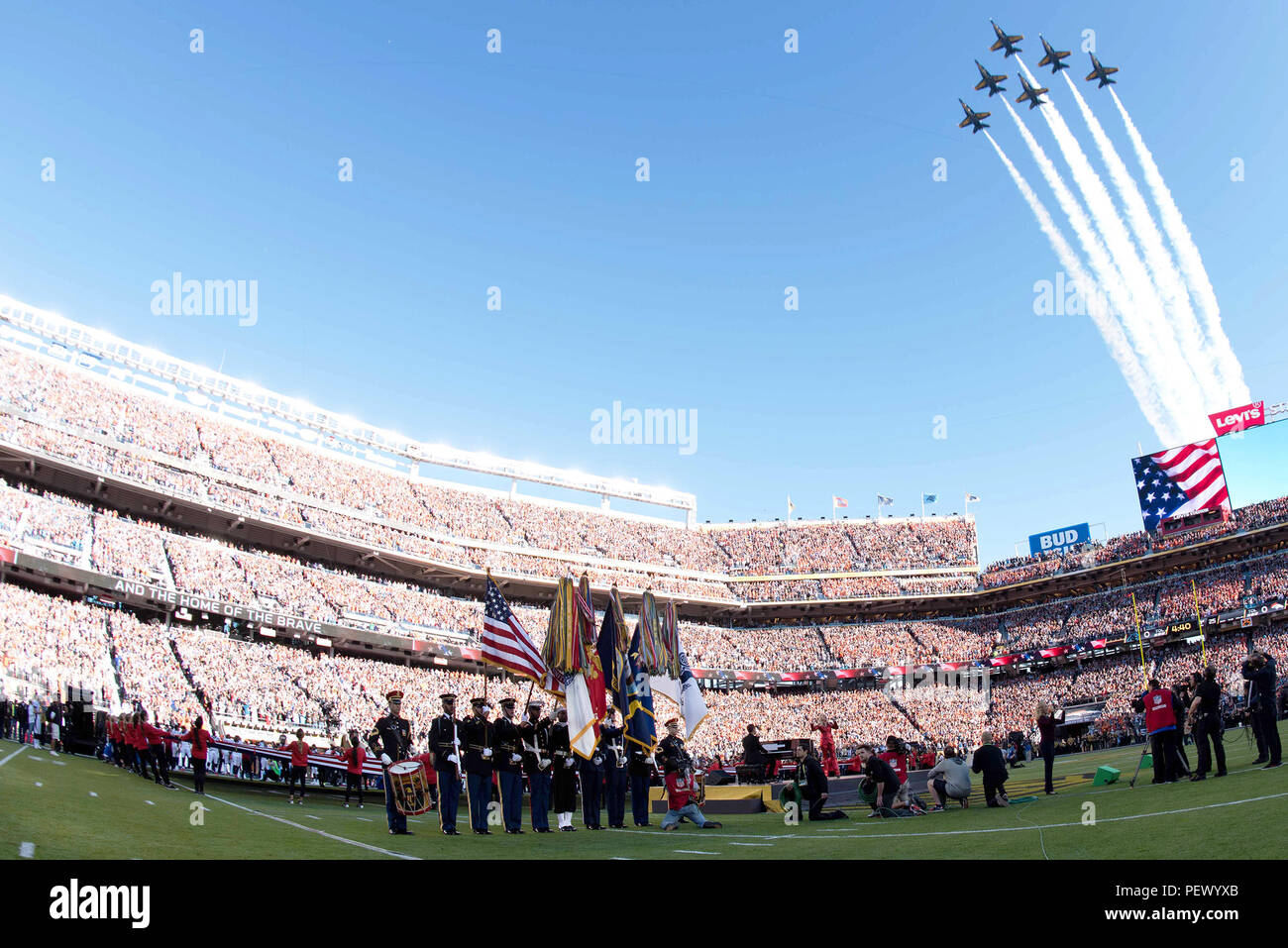 The Joint Armed Forces Color Guard presents the national colors during the opening ceremony of Super Bowl 50 Feb. 7, 2016, as the Navy’s Blue Angels fly over Levi’s Stadium, Santa Clara, Calif. The opening ceremony included the performance by a Joint Armed Services Choir followed by the singing of the national anthem by Lady Gaga. Members of The U.S. Army Band “Pershing’s Own” and the U.S. Army Military District of Washington participated in the opening ceremony. (U.S. Army Photo by Spc. Brandon C. Dyer Stock Photo