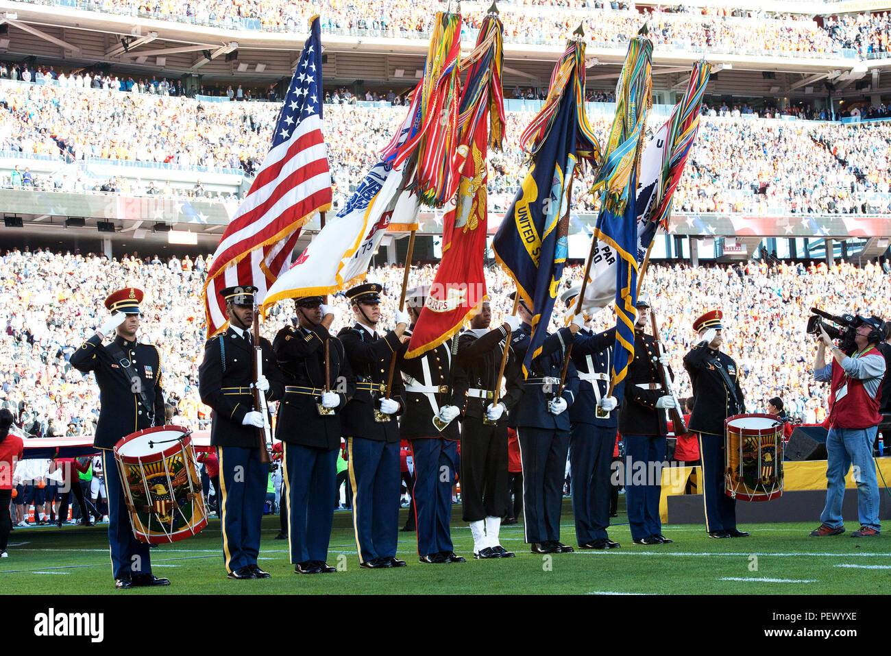 The Joint Armed Forces Color Guard presents the national colors during the signing of the national anthem before the start of Super Bowl 50 Feb. 7 in Levi’s Stadium, Santa Clara, Calif. The opening ceremony included a performance by the Joint Armes Services Choir followed by the singing of the National Anthem by Lady Gaga. Members of The U.S. Army Band “Pershing’s Own” and the U.S. Army Military District of Washington participated in the opening ceremony. (U.S. Army Photo by Spc. Brandon C. Dyer) Stock Photo