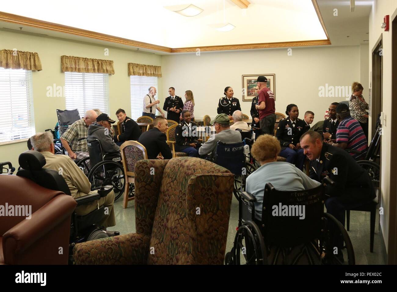 Soldiers from 69th Air Defense Artillery Brigade, speak with veterans, Nov. 10, at the William R. Courtney Texas State Veterans Home in Temple, Texas. (U.S. Army photo by Staff Sgt. Kimberly Lessmeister/ 69th ADA Bde. Public Affairs Office) Stock Photo