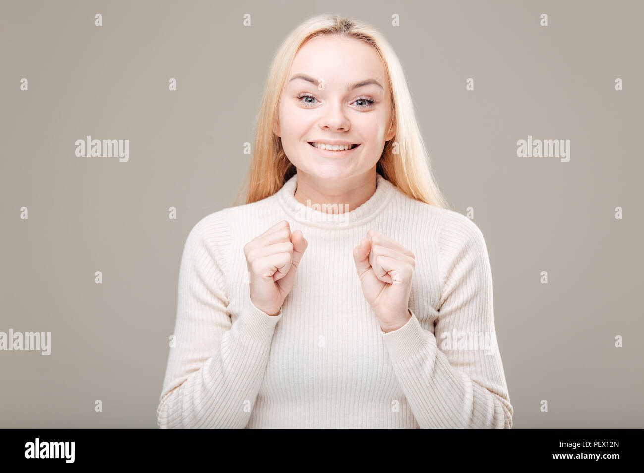 Surprised young woman in glasses over gray background Stock Photo - Alamy