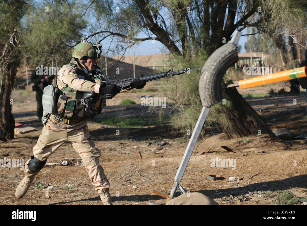 An Iraqi soldier assigned to the 71st Iraqi Army Brigade thrusts his ...