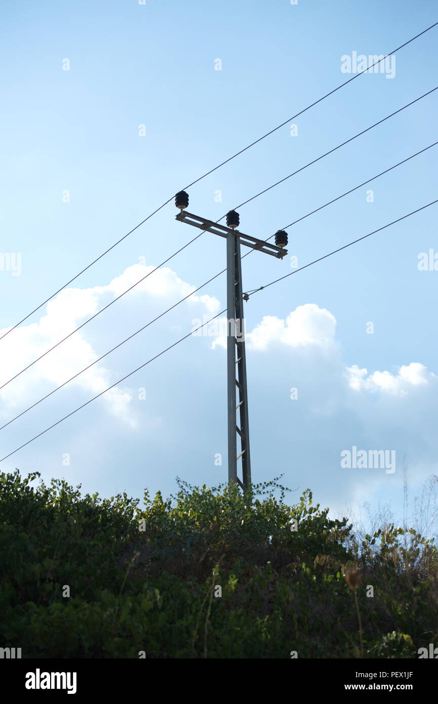 Electric pillar against blue sky Stock Photo