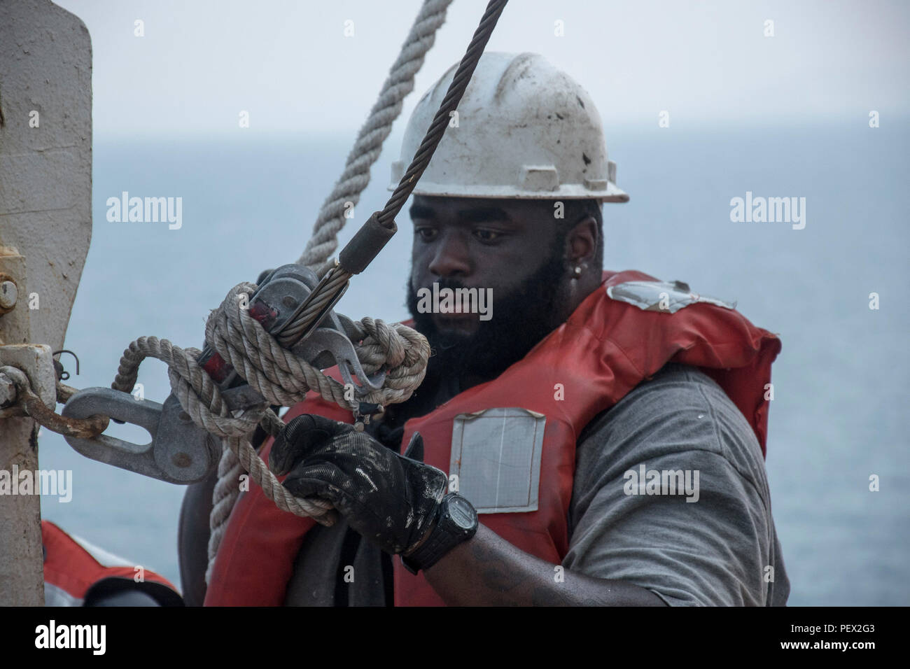 160213-N-OU129-040 GULF OF THAILAND (Feb. 13, 2016) Able-Body Seaman Kenneth Hardy participates in lifeboat deployment training during an abandon ship drill aboard USNS 1st LT Jack Lummus (T-AK 3011) while anchored in the Gulf of Thailand Feb 13. Lummus is a Military Sealift Command Marine Prepositioning Force ship supporting Exercise Cobra Gold 2016. (U.S. Navy photo by Mass Communication Specialist 3rd Class Joshua Fulton/Released) Stock Photo