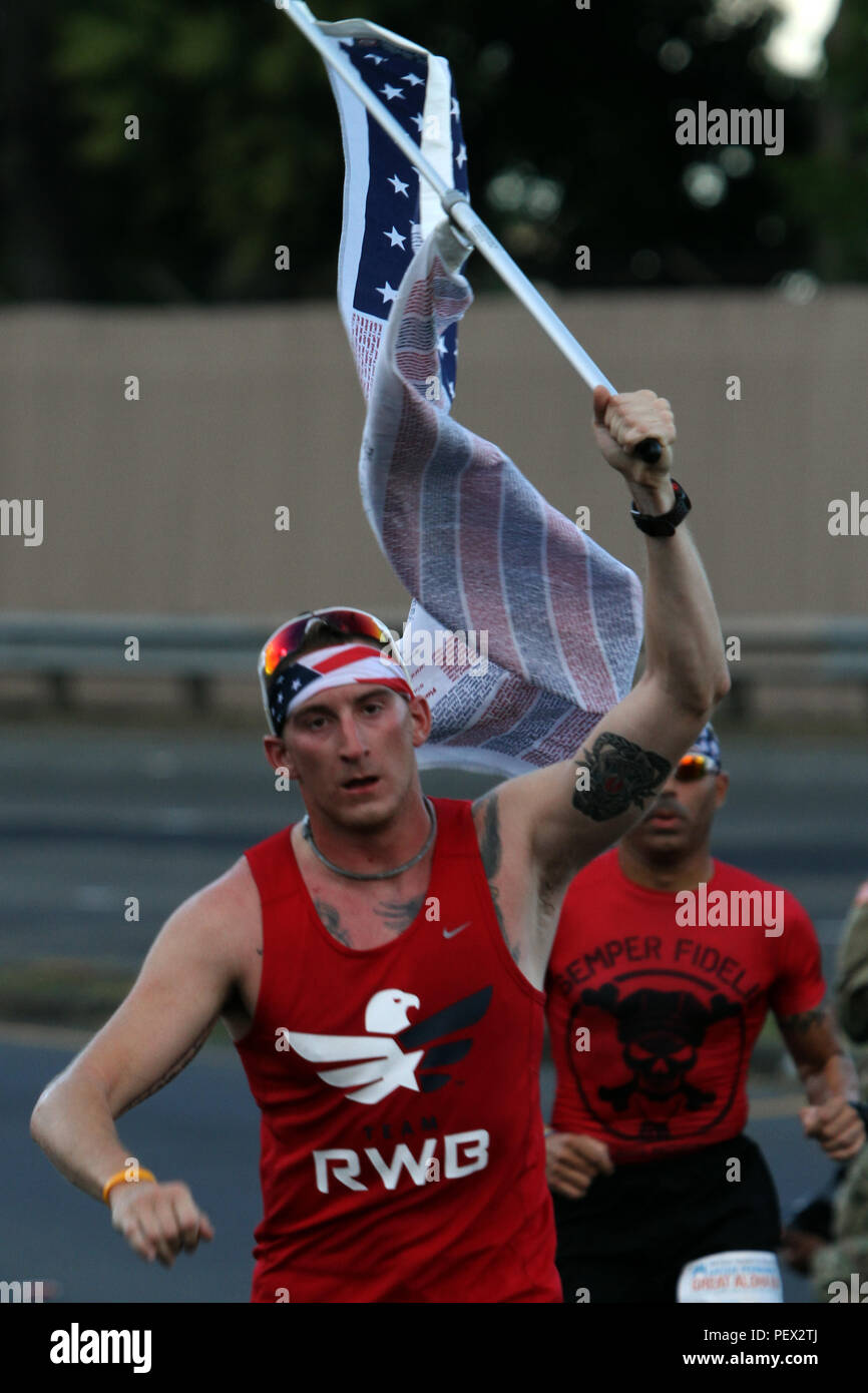 Runners pass a water checkpoint during the Great Aloha Run in Pearl Harbor, Hawaii Feb. 15, 2016.  The Great Aloha Run is an annual charity event with more than 30,000 participants and 6,000 military service members. Marines participated in the Sounds of Freedom portion of the race, where they ran in memory of the fallen Marines from Marine Heavy Helicopter Squadron 463. (U.S. Marine Corps photograph by Staff Sgt. Jason W. Fudge) Stock Photo