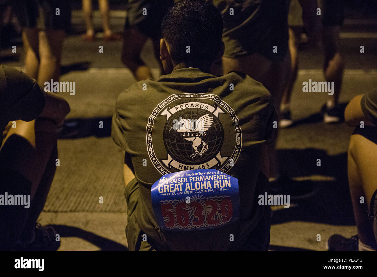 U.S. Marine Corps Forces, Pacific Marines wait in preparation for the 32nd Annual Great Aloha Run in Honolulu, Feb. 15, 2016. The Marines ran a total of 8.1 miles in honor of the 12 Marines from Marine Heavy Helicopter Squadron 463 who lost their lives in a helicopter incident, Jan. 14. (U.S. Marine Corps photo by Sgt. Matthew J. Bragg) Stock Photo