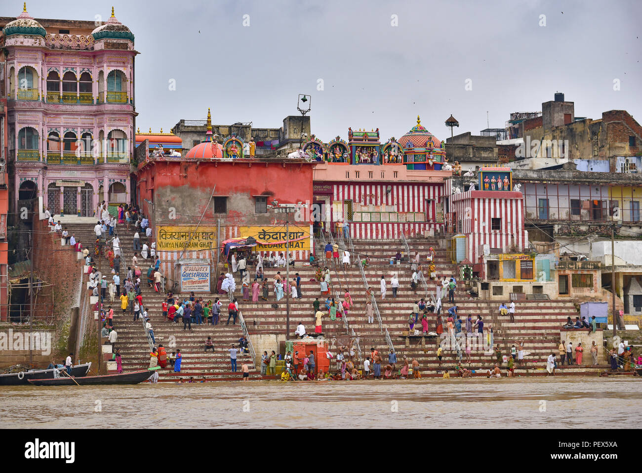 Buildings and ghat along Ganges river with people and boats Stock Photo