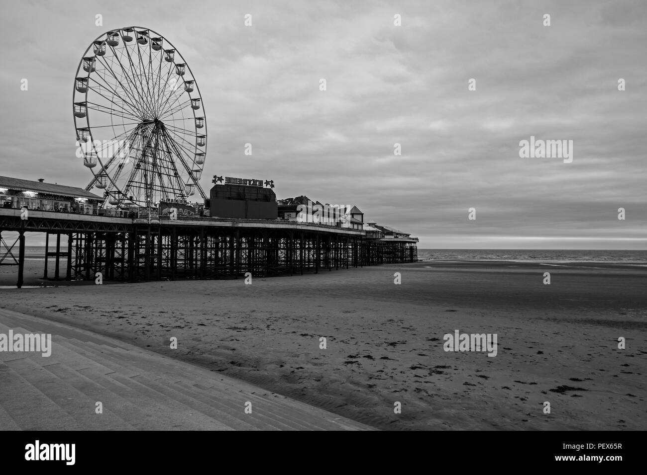 one of the piers on blackpool beach in black and white Stock Photo