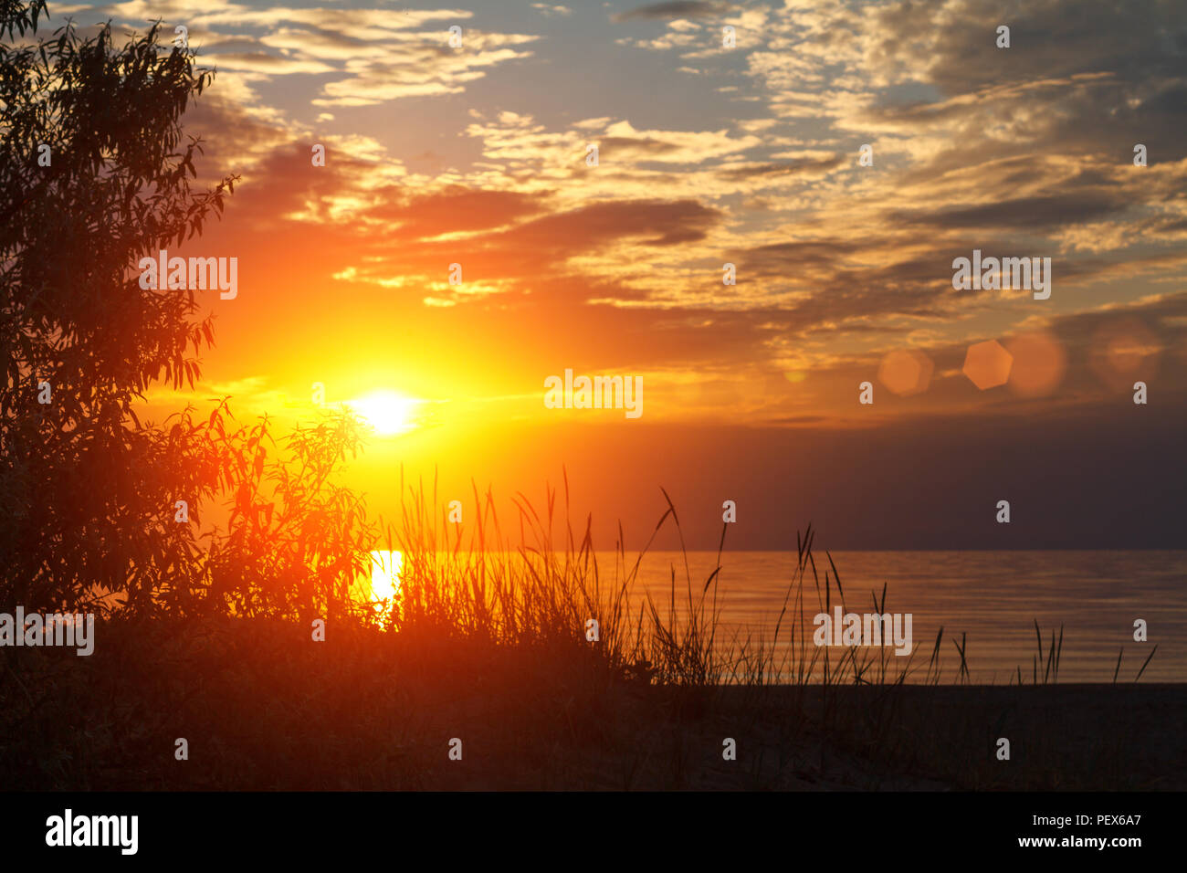 beautiful sunset in the sky with clouds over the sea Stock Photo - Alamy