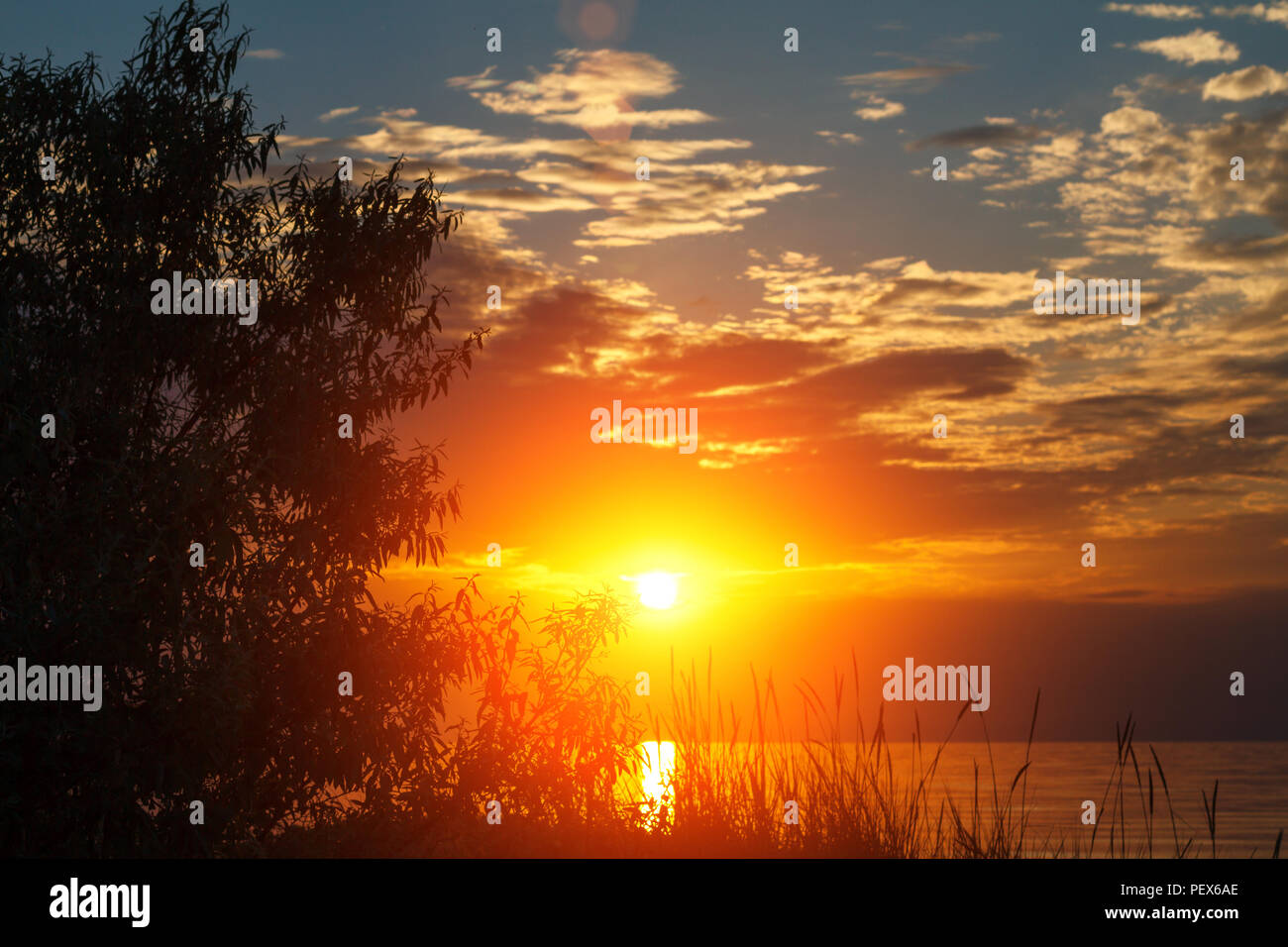 beautiful sunset in the sky with clouds over the sea Stock Photo - Alamy