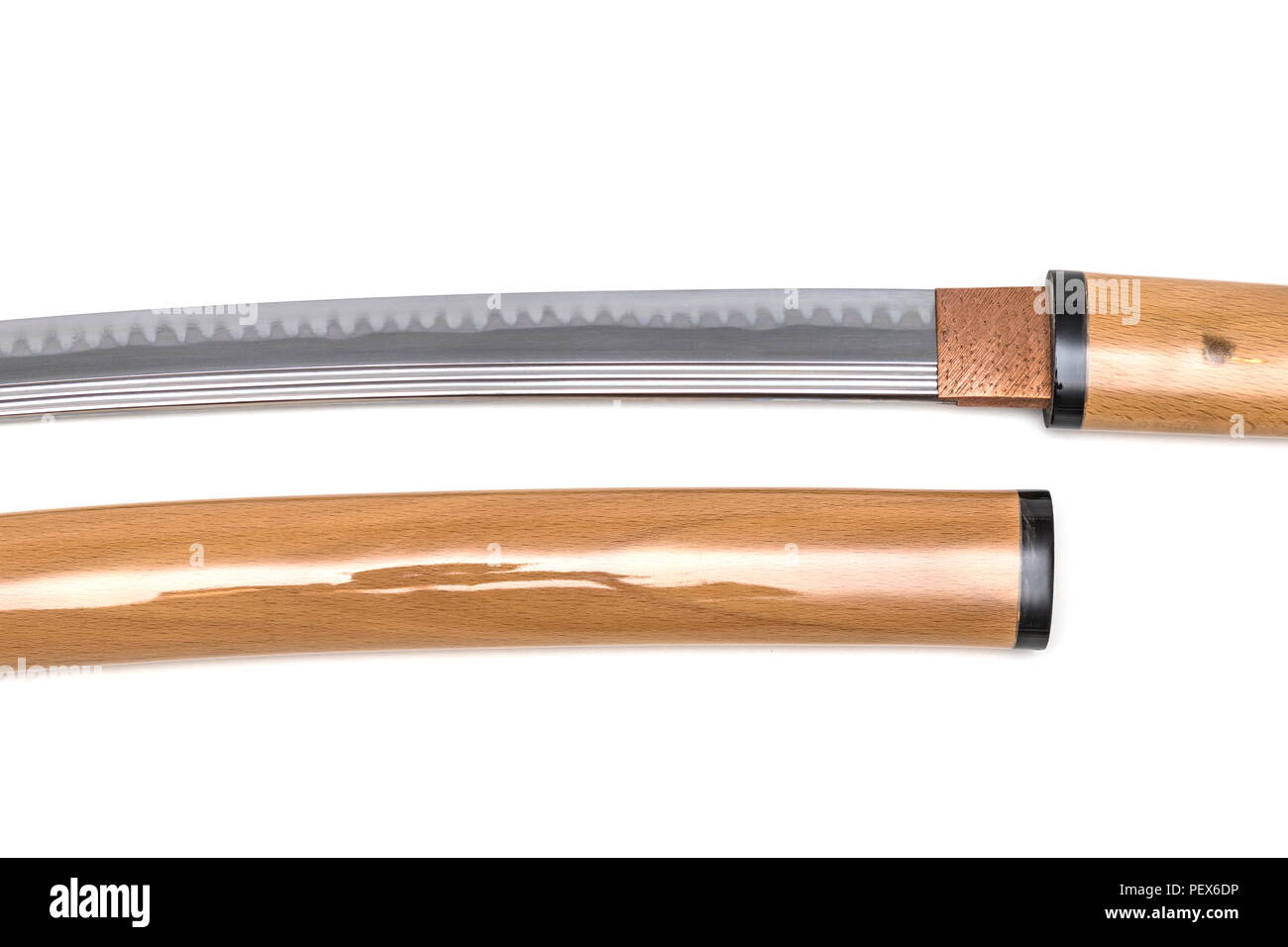 More details of blade of Japanese sword near scabbard on white