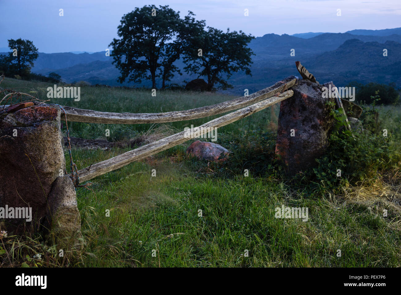 evening village scene with farm field gate, Pitoes das Junias, Alto Tras os Montes, Norte, Portugal. Stock Photo