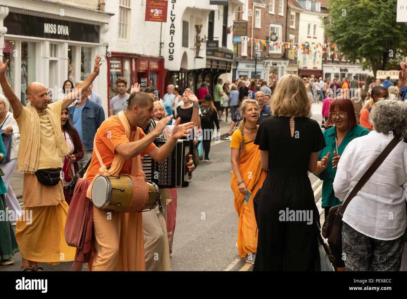 Hare Krishna's playing musical instruments and chanting in York City centre, North Yorkshire, England, UK. Stock Photo