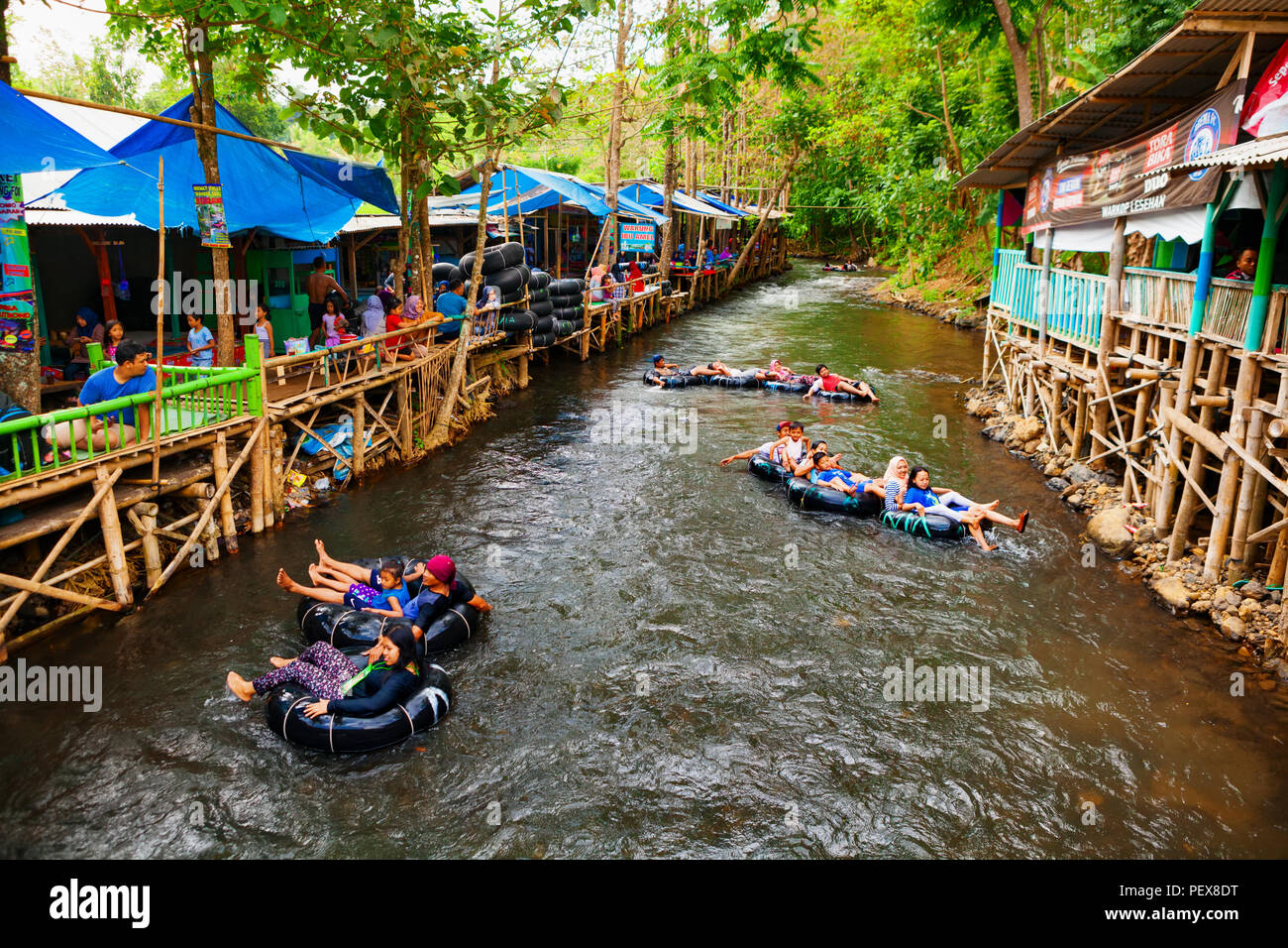 East Java, Indonesia - July 11, 2018: Sumber Maron - natural spring water spa with funny rafting on inflatable rings Popular place to visit for family Stock Photo