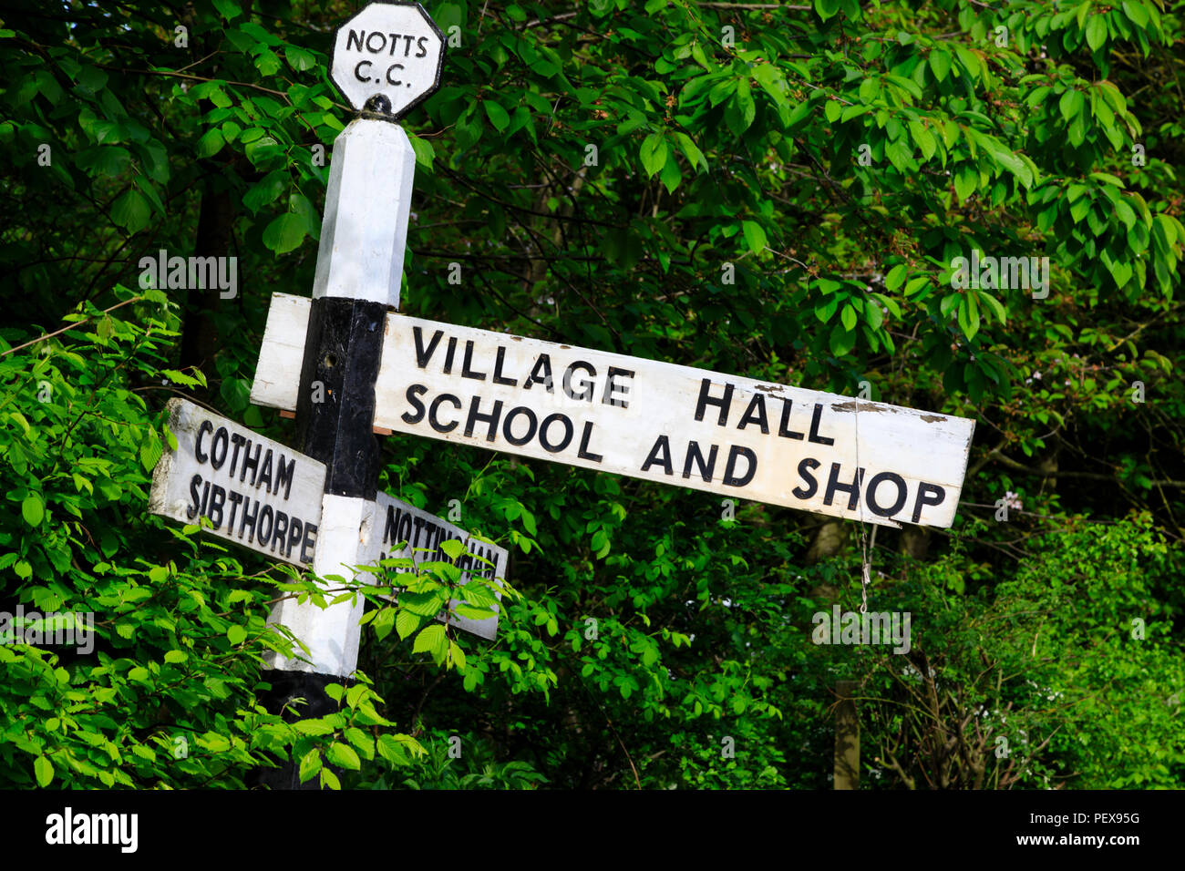 Old British road sign for the village hall, school and shop in Elston, Nottinghamshire, England. Stock Photo