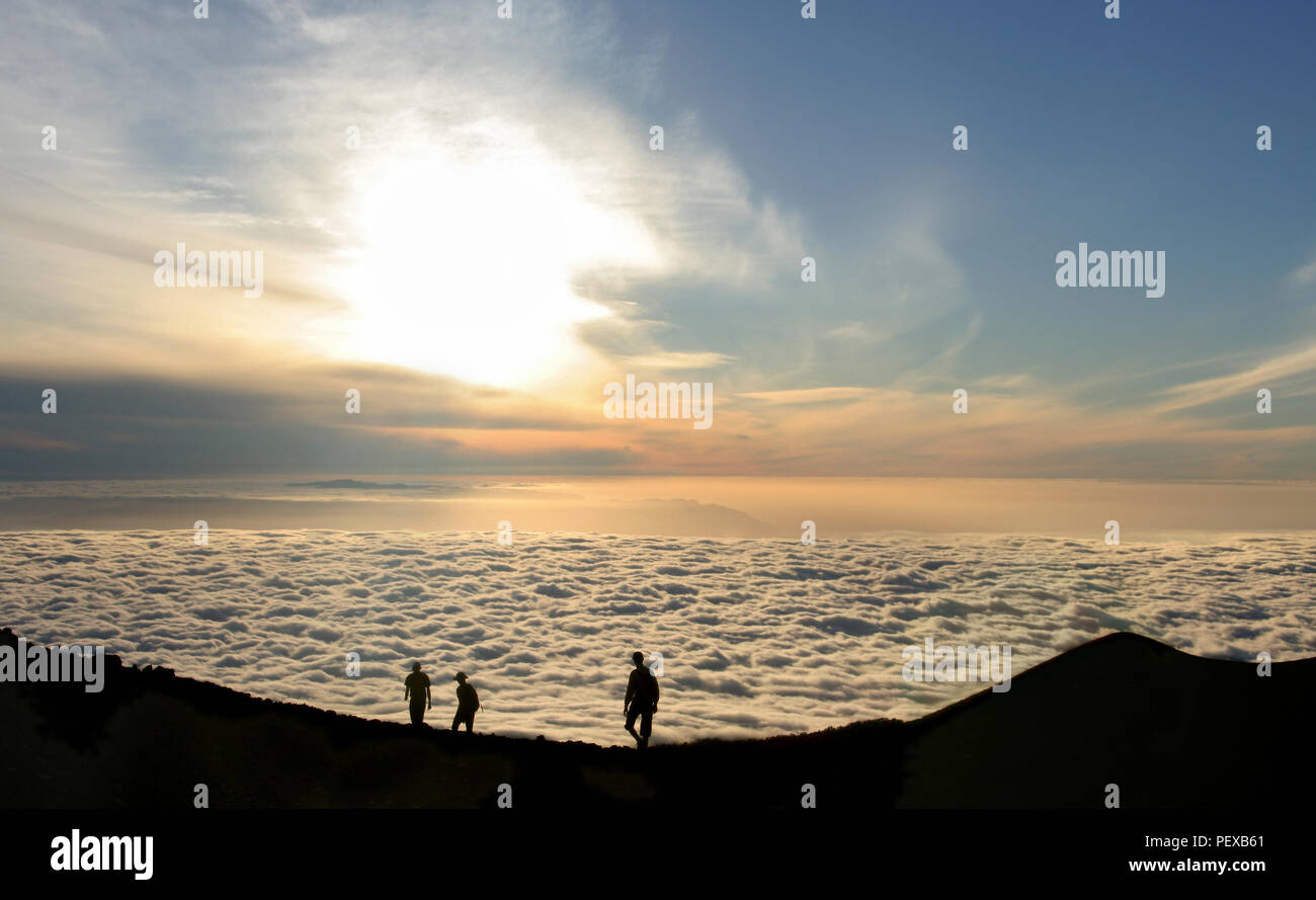 Tourists above the clouds in the evening at 2600m on the Pico Viejo in Tenerife, Spain. Stock Photo
