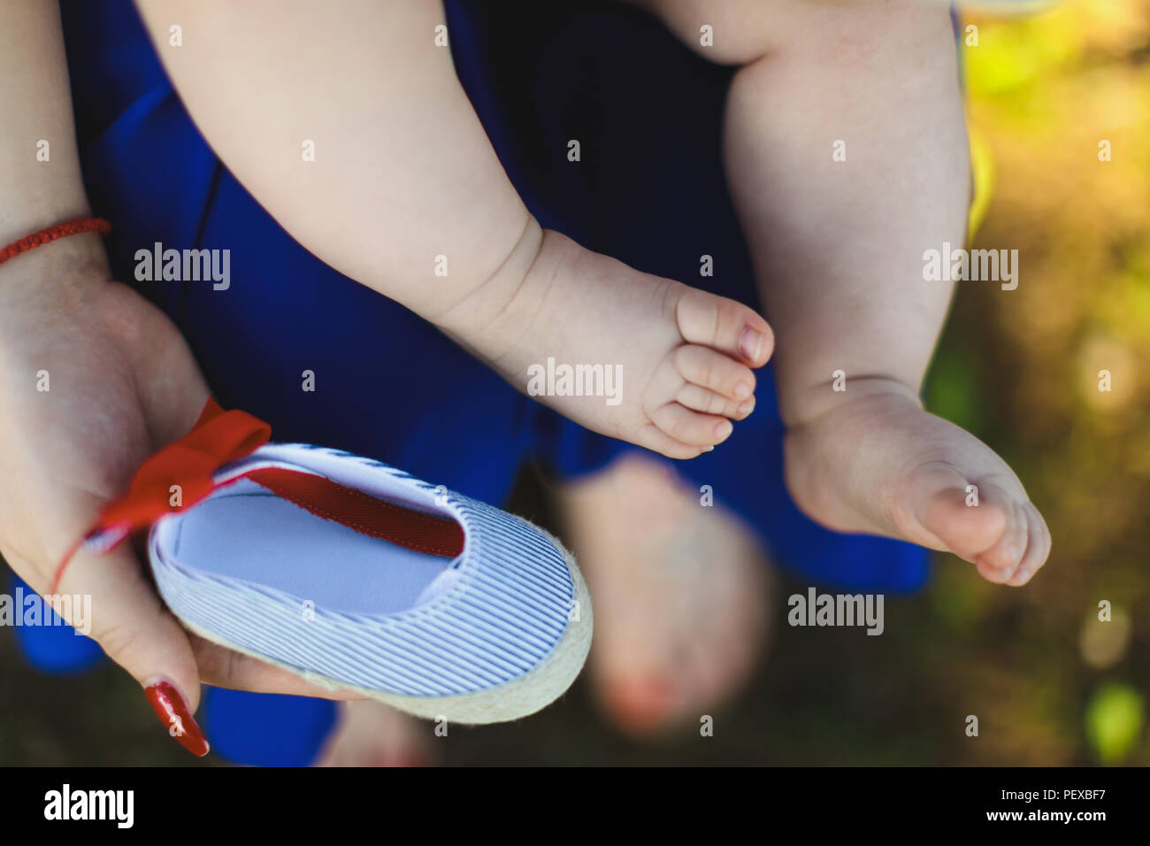 Baby leg and shoes. Baby footwear concept. Stock Photo