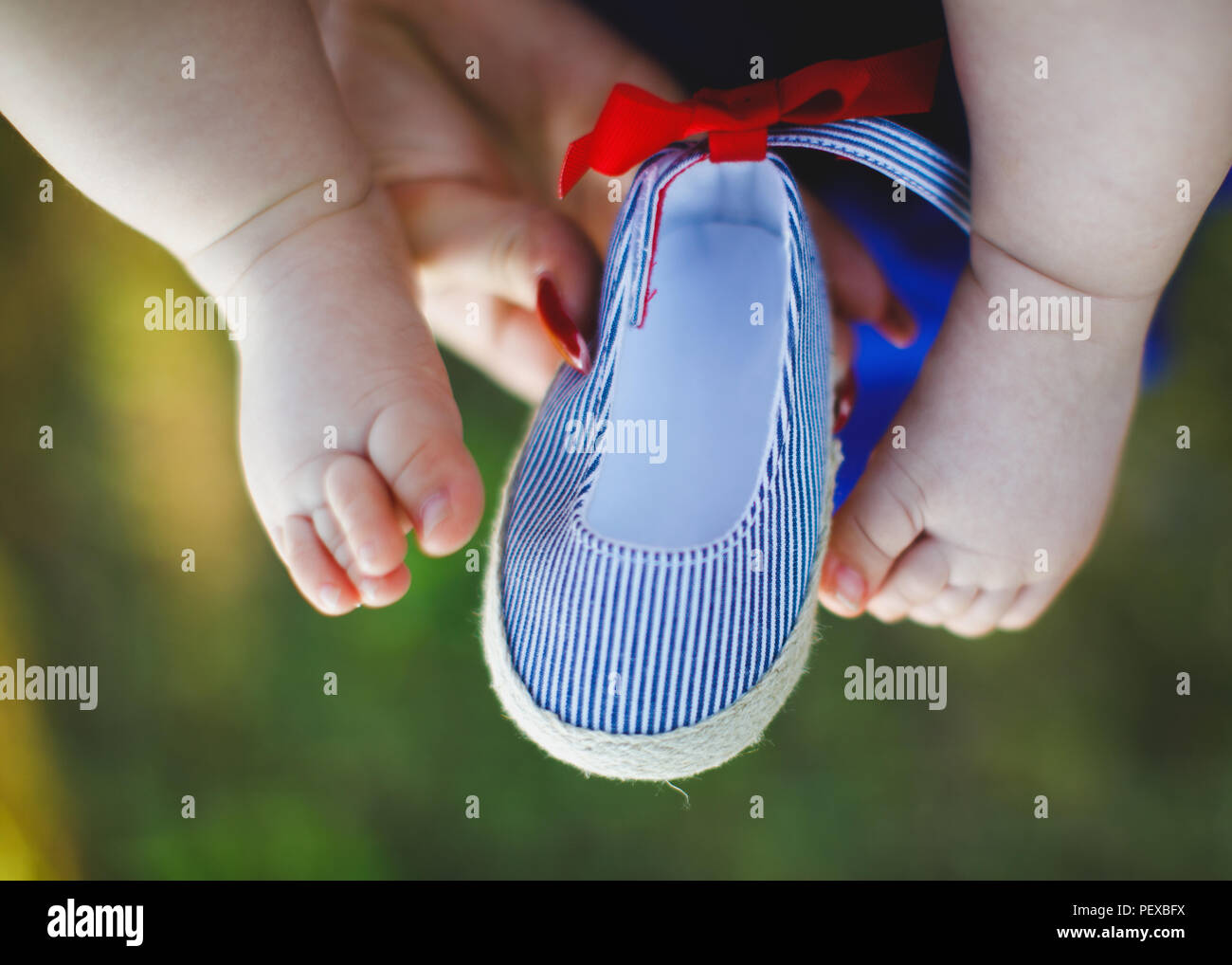 Baby leg and shoes. Baby footwear concept. Stock Photo
