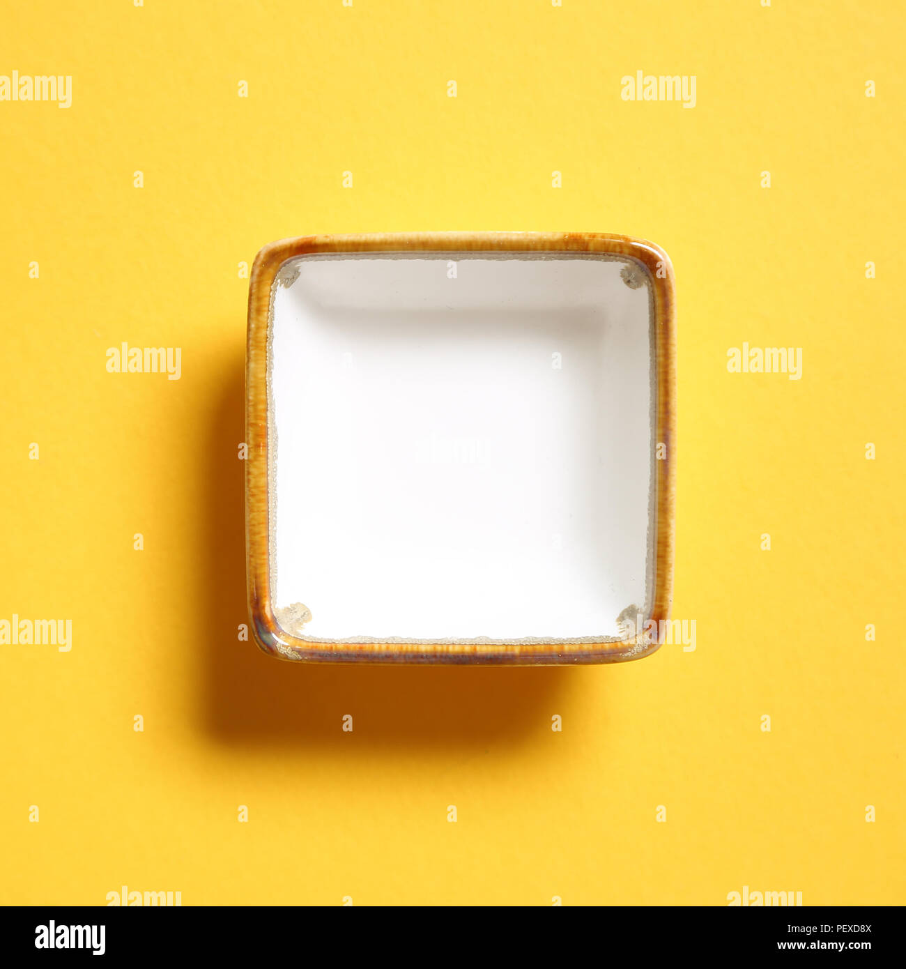 White dish isolated on yellow background Stock Photo