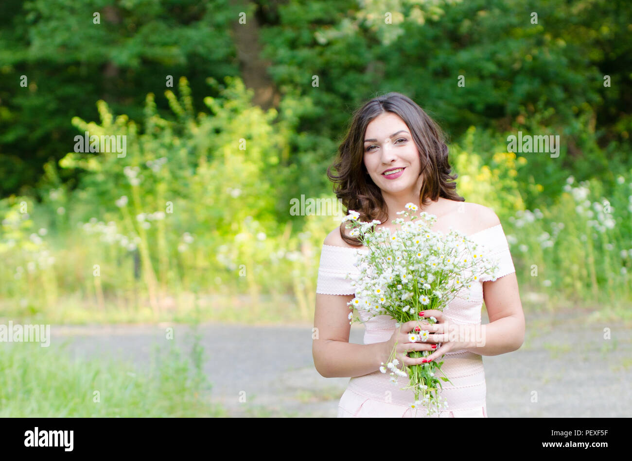 Portrait of a beautiful young girl on nature Stock Photo - Alamy