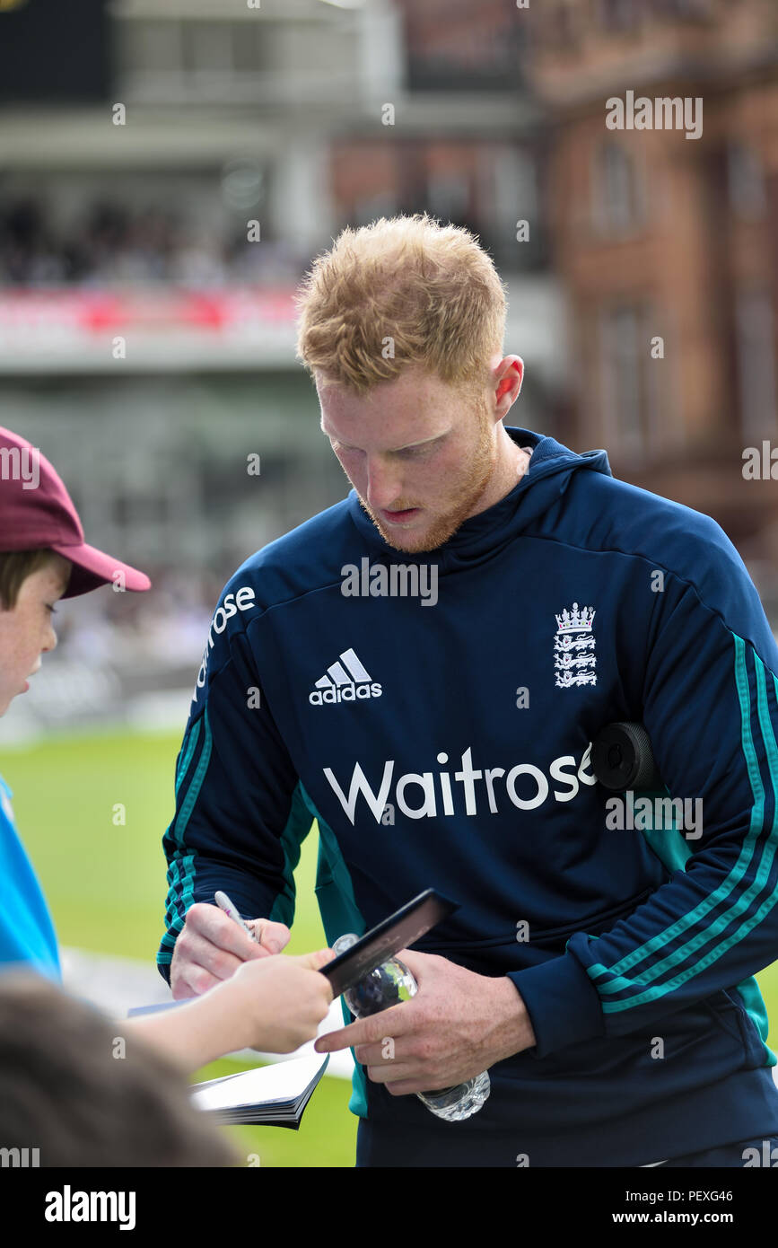 England cricketer Ben Stokes signs a young fan's autograph book at Lord's Stock Photo