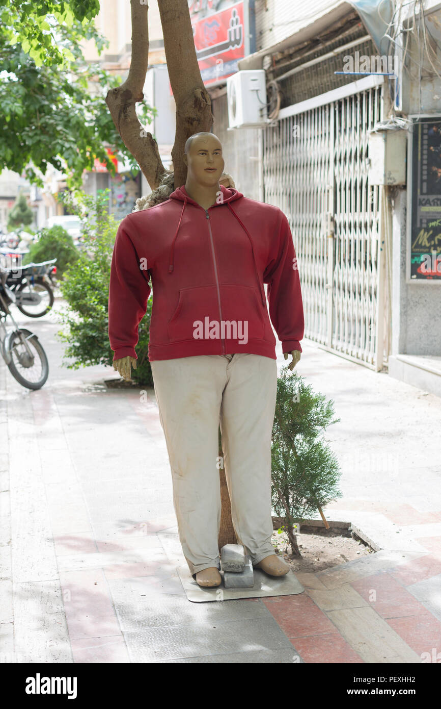 Male oversize mannequin on display outside a garment shop Stock Photo