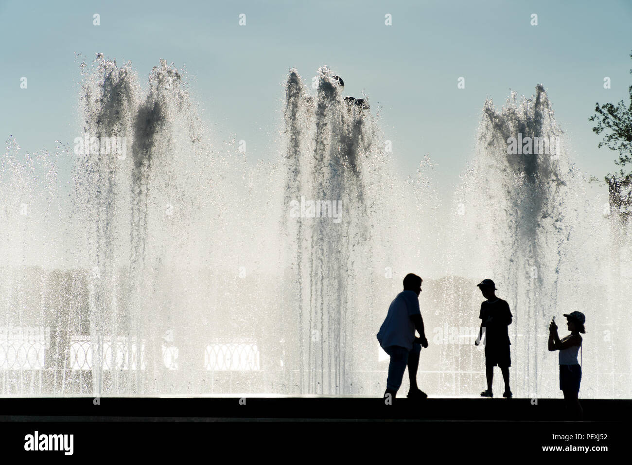 Silhouettes of people on the background of fountain Stock Photo - Alamy