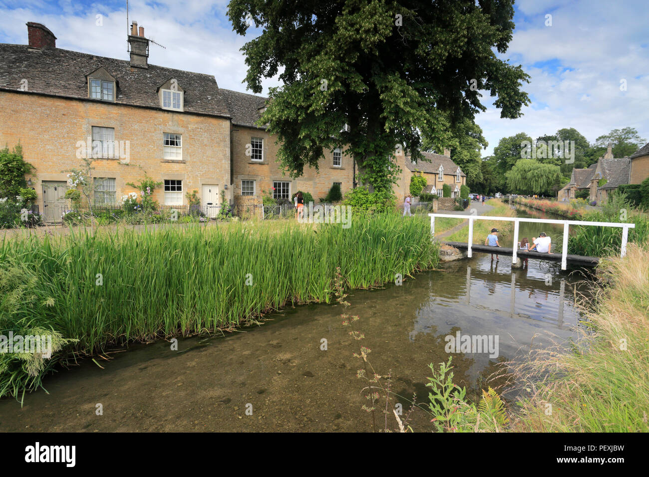 Summer view over Cottages and the River Eye, Lower Slaughter village, Gloucestershire Cotswolds, England, UK Stock Photo