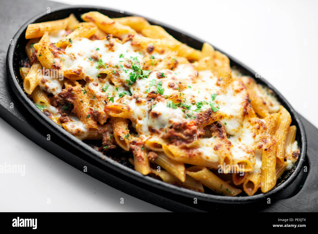 gourmet oven baked fresh pasta penne bolognese and mozzarella cheese dish Stock Photo