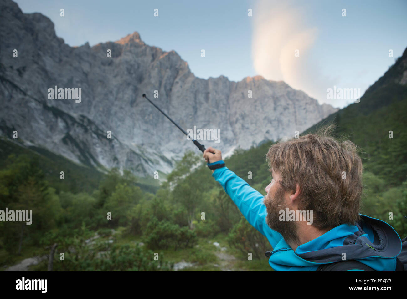 Mountain guide pointing at route at Triglav, Slovenia Stock Photo